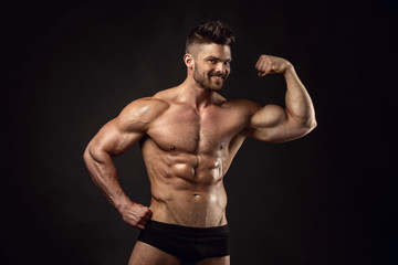 Fototapeta na wymiar Strong Athletic Man Fitness Model Torso showing big muscles