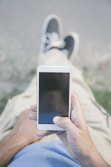 Young man with mobile phone outdoor © BGStock72