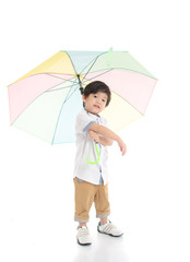 Cute asian boy holding umbrella