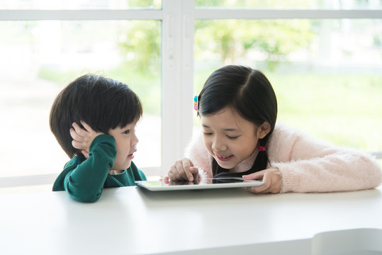 Cute asian children using tablet