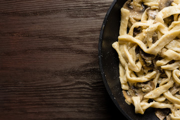 Homemade fettuccini pasta in cream sauce with mushrooms