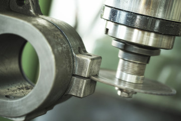 Close up shot of working industrial machine.  Visible grain. Short depth of field and selective focus.