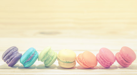 French macaroons on sack with wood background on filter color