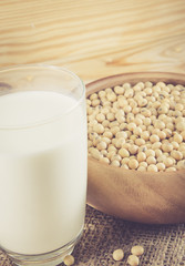 oy Milk with soy bean on wood bckground