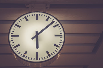 modern clock in under ground train with color filter on vintage styled