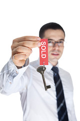 Realtor Holding Up Old Key