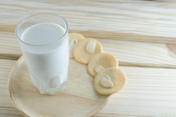 milk and cookie on wooden board background