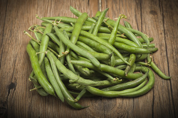 Group of green beans on the wood.