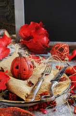 pumpkin on a background of dry plants and candles
