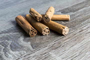 Cinnamon sticks isolated on brown wooden background