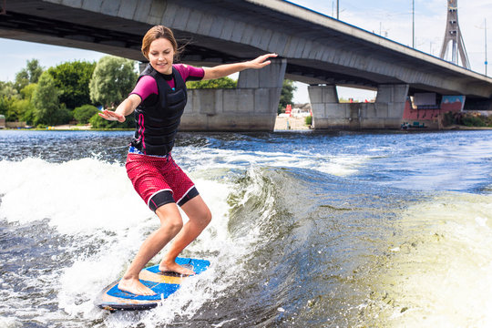 Girl Rides A Study Wakesurfing