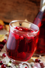 Hot mulled wine with cranberries on the background of autumn, se