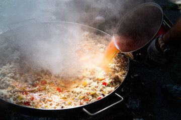 Preparing paella with broth