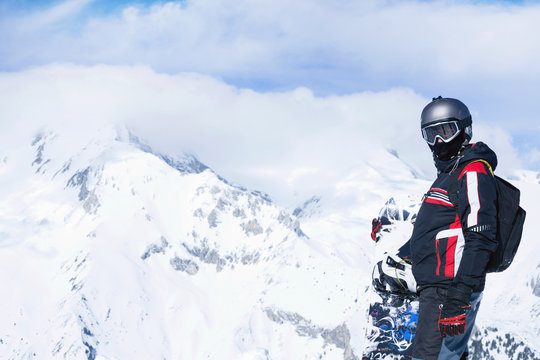 snowboarder against panoramic winter mountains