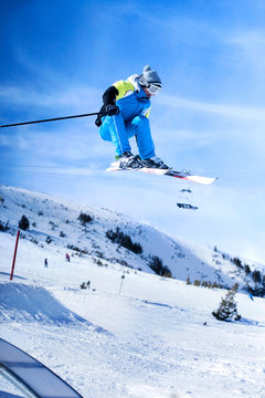 Jumping skier against blue sky
