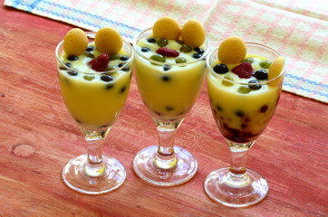 Hot homemade vanilla pudding with strawberries and vine berries