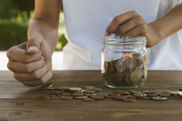 hand counting coins savings
