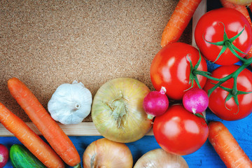 Fresh vegetables and cork board
