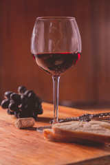 Red wine against wooden background