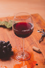 Red wine against wooden background