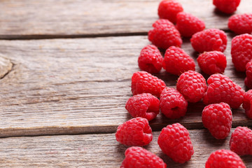 Red raspberries on grey wooden background