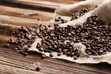 Roasted coffee beans on a brown wooden background