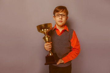 European-looking  boy of  ten years in glasses holding a cup, aw