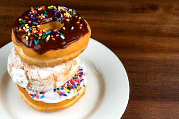 Stacked donuts on brown table. Shallow depth of field 