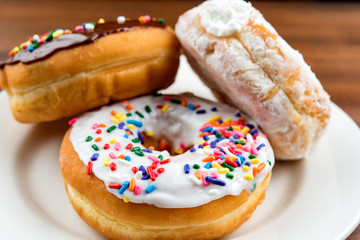 Stacked donuts on brown table. Shallow depth of field 