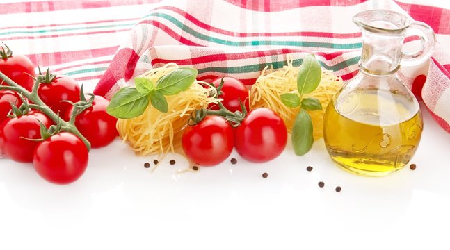 Photo of tagliatelle with cherry tomatoes,basil,oil,garlic at the top on white