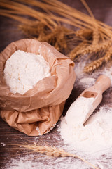 Flour in  bag and wooden spoon