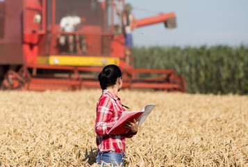 Woman agronomist in wheat field