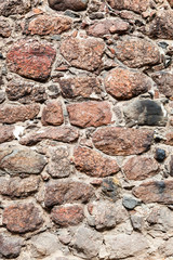 Fragment of a natural old stone wall as background