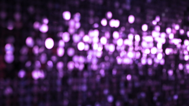 Sequins violet sparkling reflective background. 