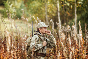Fototapeta premium man hunter with shotgun in forest
