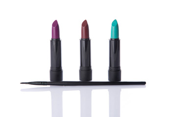Obraz premium Trendy lipsticks and makeup brush