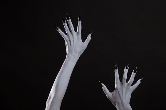 Pale ghost or witch hands with sharp black nails