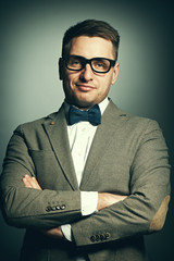 Confident nerd in eyeglasses and bow tie