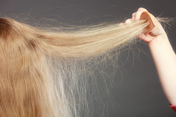 Closeup of woman with static blonde hair.