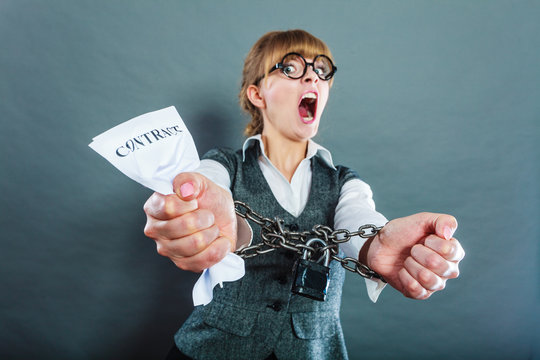 Furious woman with chained hands and contract