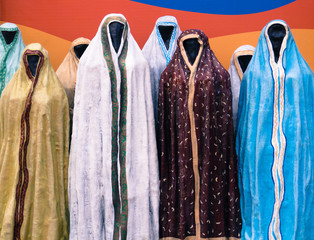 mannequins wearing robes ,chadors, abayas in many colors and patterns to cover women in traditional...