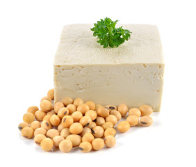 Tofu and soybeans on white background.