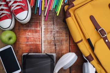 Outfit of traveler, student, teenager, young woman or guy. Overhead of essentials for modern young person. Different objects on wooden background.