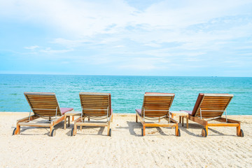 Fototapeta na wymiar Umbrella and chair on beautiful tropical beach
