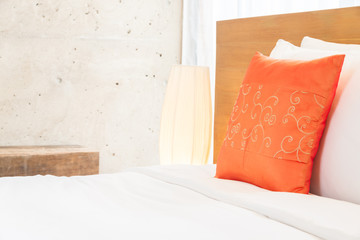 Beautiful luxury bedroom interior with orange pillow decoration