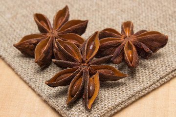 Star anise on jute canvas on wooden table, seasoning for cooking
