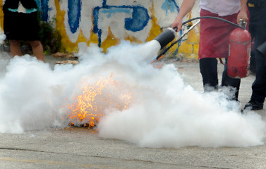 Close up of extinguishes a fire, fire extinguisher on a training fire 