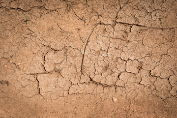 Crack soil dry season on sand background.