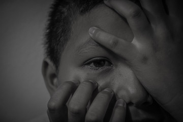 Young homeless Asian boy scared and alone, he is at high risk of being abused and trafficked