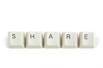 share from scattered keyboard keys on white